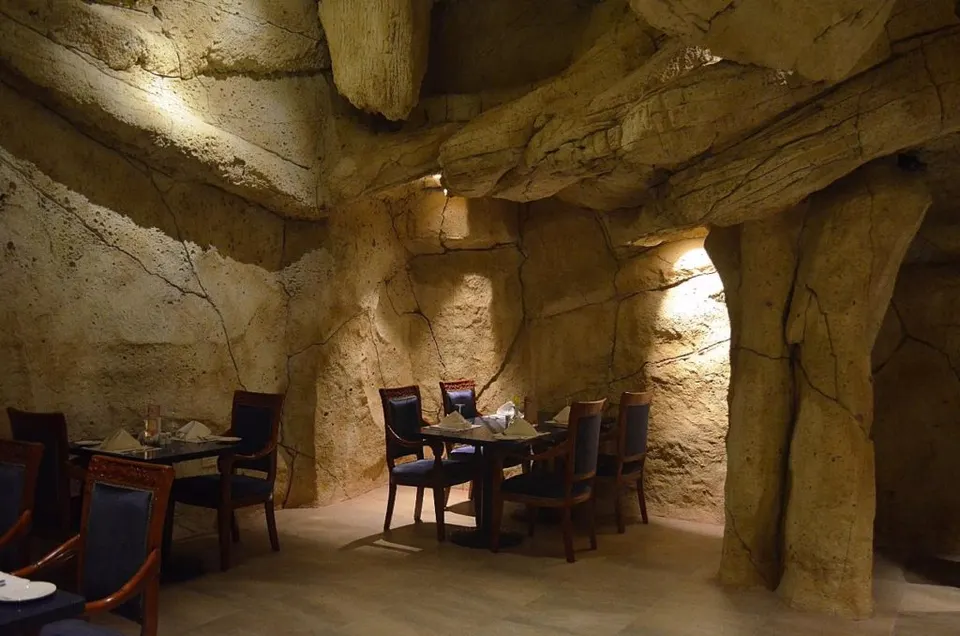 An alcove seating bay carved into the rock, table set for service